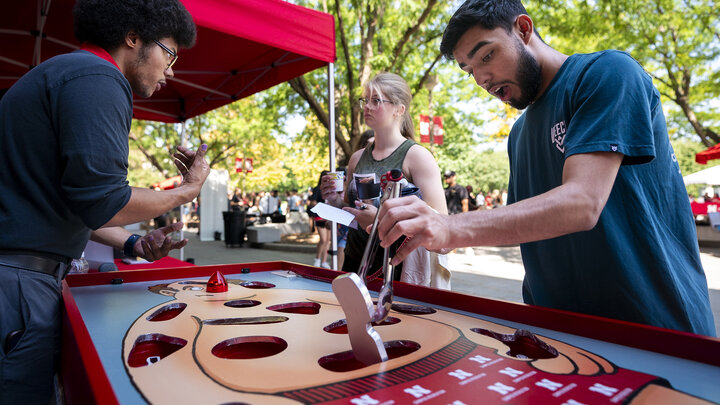 Damian Flores, right, reacts as he tries to pull and object out of a hole during a game of Operation.